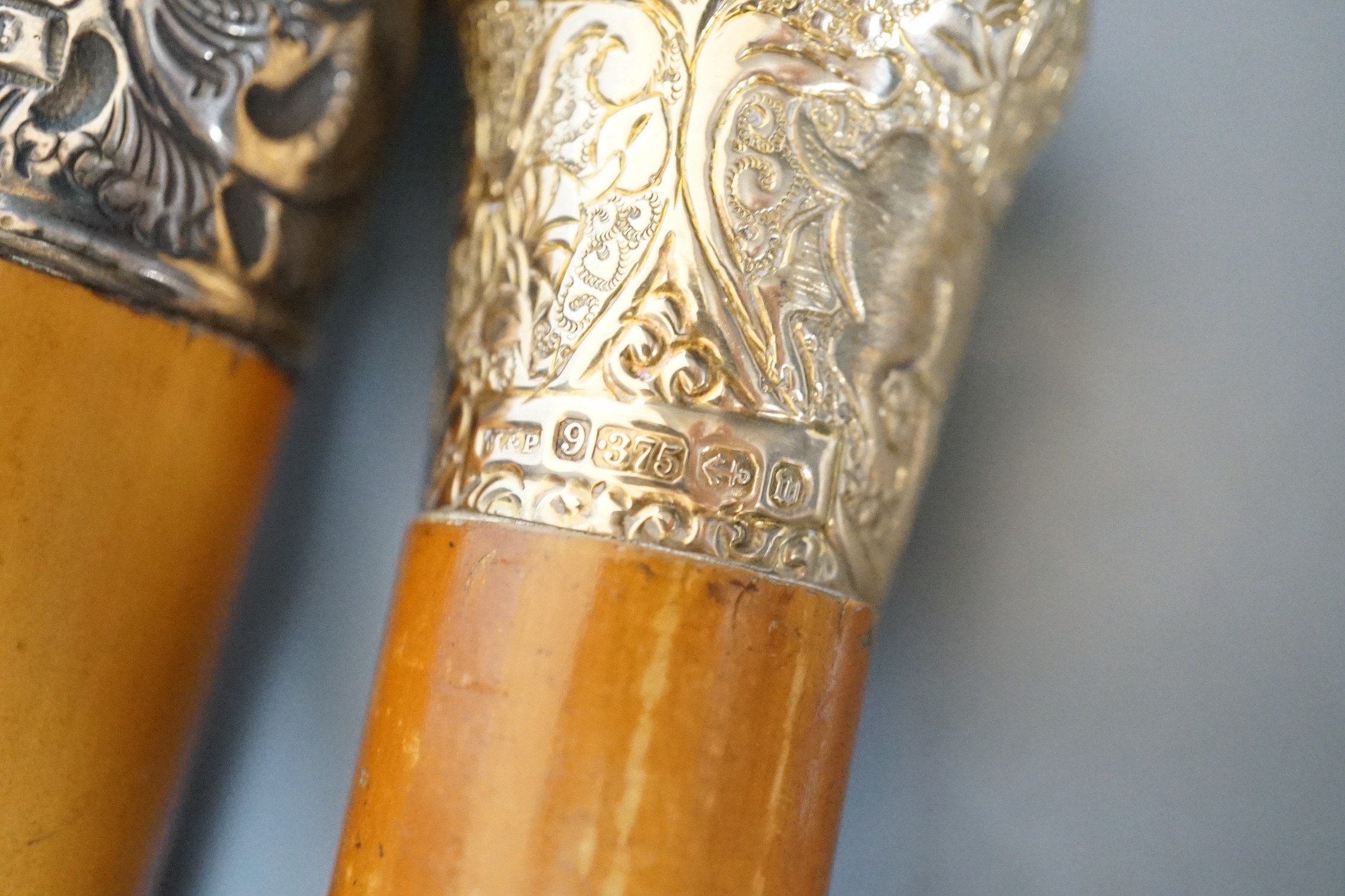 Two 19th century malacca walking canes: one with an Indian inspired 9ct gold handle, the other with a silver embossed handle, gold handled cane 92 cms long